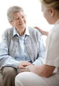 Smiling older woman with caregiver