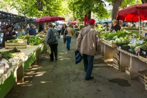 People walking around an outdoor farmer's market