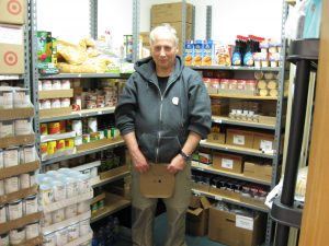 An RSVP Volunteer in the food pantry