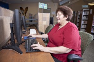 Woman surfing the internet at a library computer