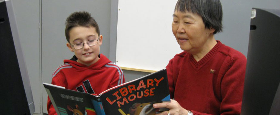 An RSVP Volunteer reading to a child in our child literacy program