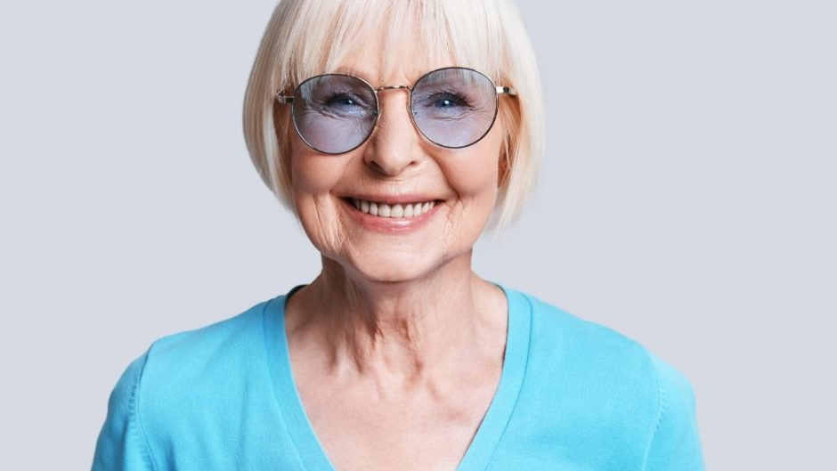 Smiling blonde woman with round glasses