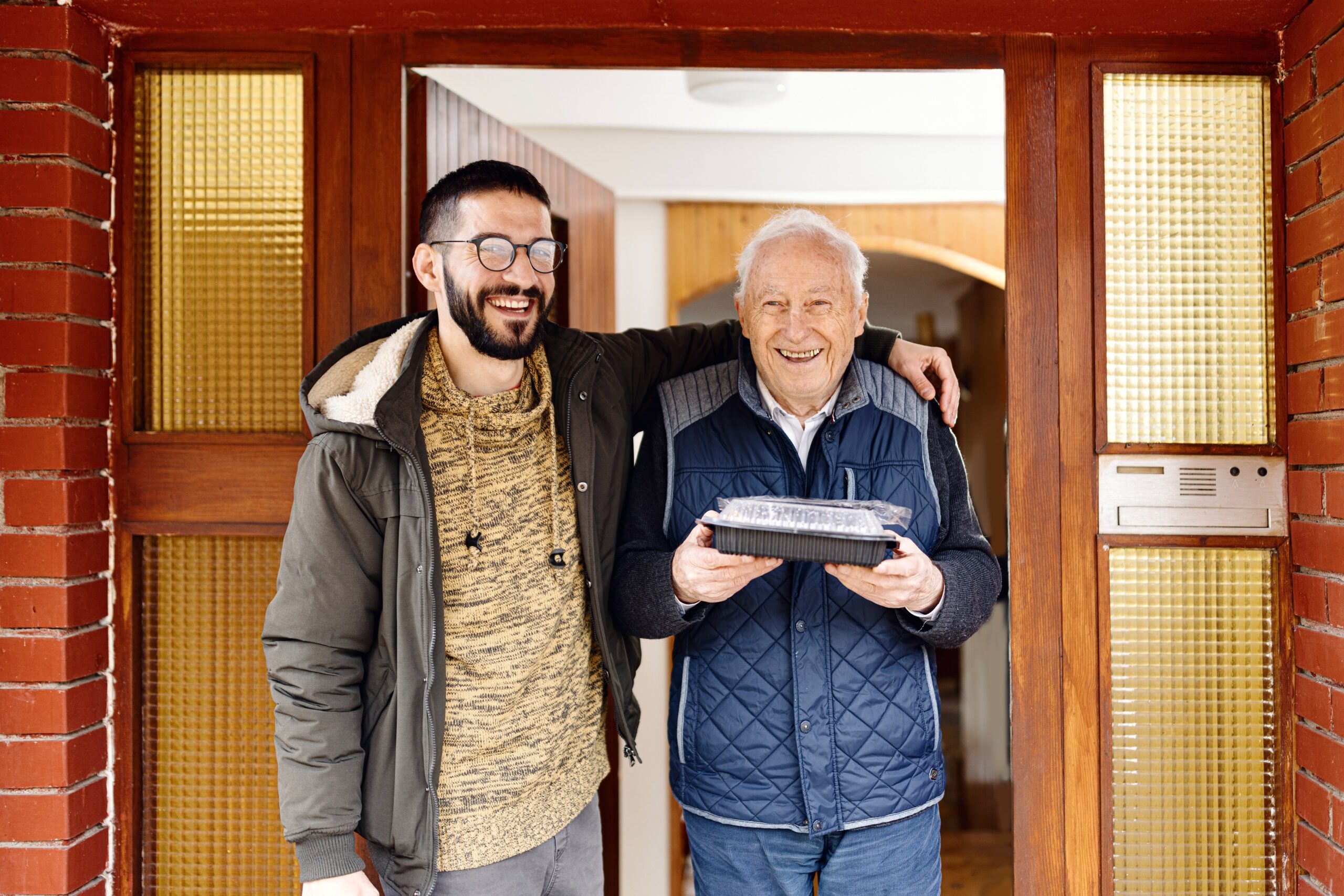Meals on Wheels Volunteer with client holding meal